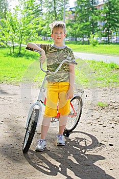 Happy flushed boy teen finished training on the bike