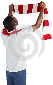 Happy football fan waving scarf