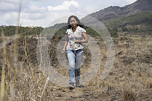 Happy free Asia woman running in the mountains. Happiness and freedom lifestyle inspiraitonal concept photo