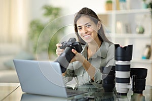 Happy freelance photographer posing at home
