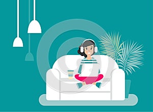 Happy freelancer girl with earphones on sofa with laptop. creative hipster work at home