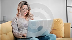 Happy freelancer lady smiling chatting work remote on laptop pc. Shot with RED camera in 4K