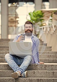 happy freelancer man has communication on pc outdoor. communication of freelancer man outside