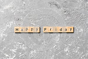 Happy friday word written on wood block. Happy friday text on cement table for your desing, concept