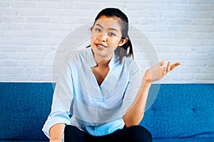 Happy friendly Asian woman looking at camera and talking, making video call conference, online job interview at home