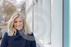 Happy friendly blond woman with tousled long hair