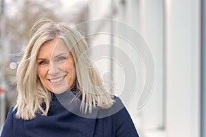 Happy friendly blond woman with tousled long hair