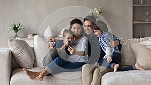 Happy friendly family with kids using cellphone.