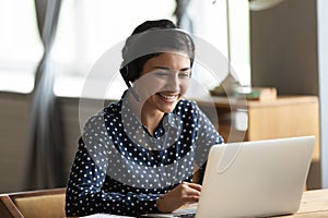 Happy friendly indian woman holding video call with friends.