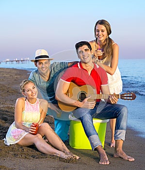 Happy Friends at the Beach Looking at the Camera