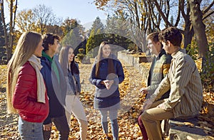 Happy friends chatting animatedly with each other in park