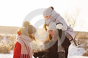 Group of teenage friends having fun snow in winter
