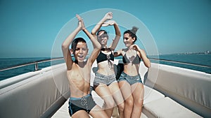 Happy friends dancing on a yacht