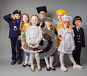 Happy friends dressed as doctor, cook, judge, policeman, agent fbi and singer. photo