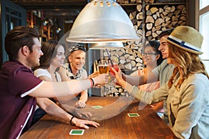 Happy friends drinking beer at bar or pub