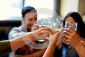 Happy friends drinking beer at bar or pub