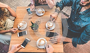 Happy friends drinking cappuccino inside vintage bar - Top view of trendy young people doing meeting at breakfast - Millennial