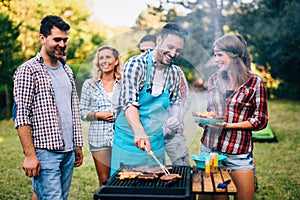 Happy friends enjoying barbecue party