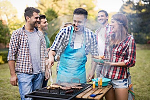 Happy friends enjoying barbecue party