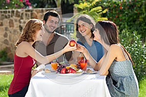 Happy friends enjoying a healthy meal