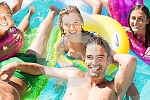 Happy friends enjoying in the swimming pool