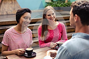 Happy friends having coffee together