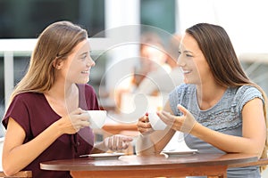 Happy friends having a conversation in a bar