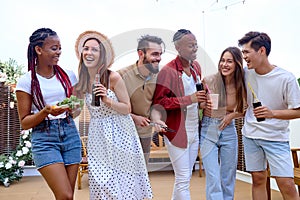 Happy friends having fun drinking lemonade, talking. Milenial people enjoying party time