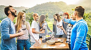 Happy friends having fun drinking red wine in vineyard - Milenial people enjoying harvest time together at countryside farm house