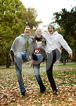 Happy friends having fun in park laughing