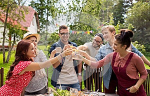 Happy friends having party at summer garden