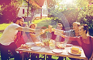 Happy friends having party at summer garden