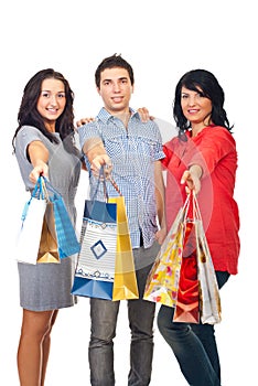 Happy friends holding shopping bags