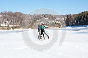 Happy friends jumping on a frozen lake