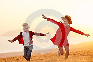Happy friends kids enjoying summer evening in countryside