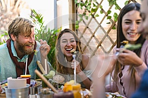 Happy friends lunching with healthy food in bar coffee brunch - Young people having fun eating meal and drinking fresh smoothies