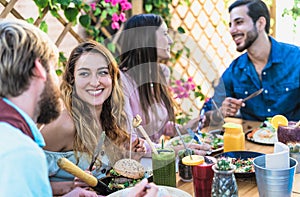 Happy friends lunching with healthy food in bar coffee brunch - Young people having fun eating meal and drinking fresh smoothies