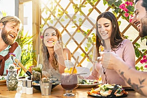 Happy friends lunching healthy food in brunch bar restaurant - Young people having fun eating and drinking smoothies fresh fruits