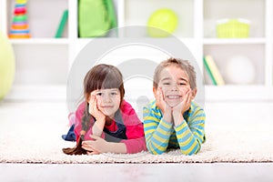 Happy friends lying on the floor