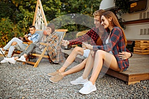 Happy friends makes selfie on picnic at camping