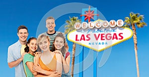 Happy friends over las vegas sign background