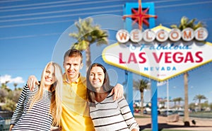 Happy friends over welcome to las vegas sign