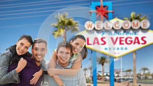 Happy friends over welcome to las vegas sign