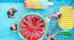 Happy friends playing with air lilo ball inside swimming pool - Young people having fun on summer holidays vacation - Travel,