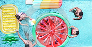 Happy friends playing with air lilo ball inside swimming pool - Young people having fun on summer holidays vacation - Travel,