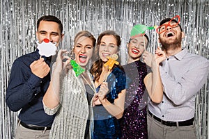 Happy friends posing with christmas party props photo