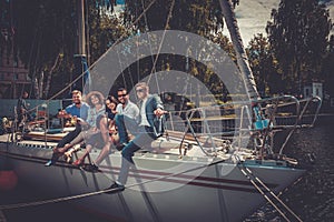 Happy friends resting on a yacht