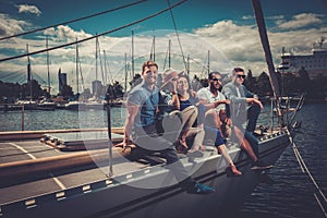 Happy friends resting on a yacht