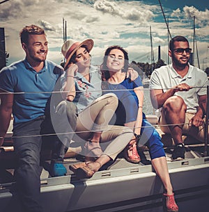 Happy friends resting on a yacht