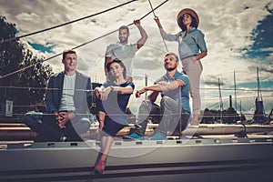 Happy friends resting on a yacht